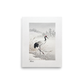 'Crane in the Frost' — a Shin hanga print. A red-crowned crane wades through a snow-covered winter marsh near frosted pine hills, adding a calm atmosphere to a bedroom.