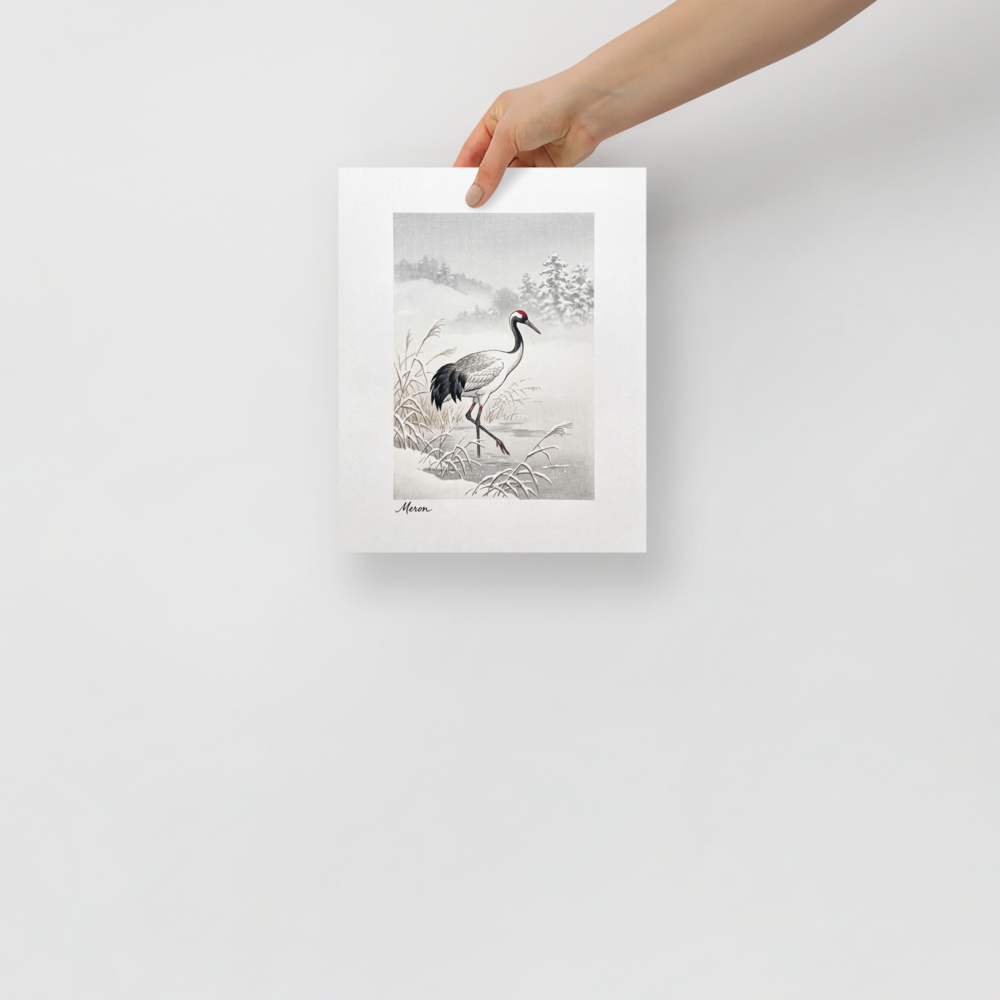 'Crane in the Frost' — a Shin hanga print. A red-crowned crane wades through a snow-covered winter marsh near frosted pine hills, adding a calm atmosphere to a bedroom.