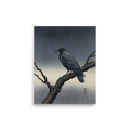 'Solitary Raven at Dusk' — a Shin hanga print. A dark raven perches on a mossy winter branch against a textured gray woodblock background, bringing a calm aesthetic to an office.