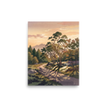 'Dappled Sunset Path', part of Meron's Shin hanga wall art. A winding forest path dappled with tree shadows leads toward distant mountains under a warm peach evening sky, ideal for a tranquil living room.