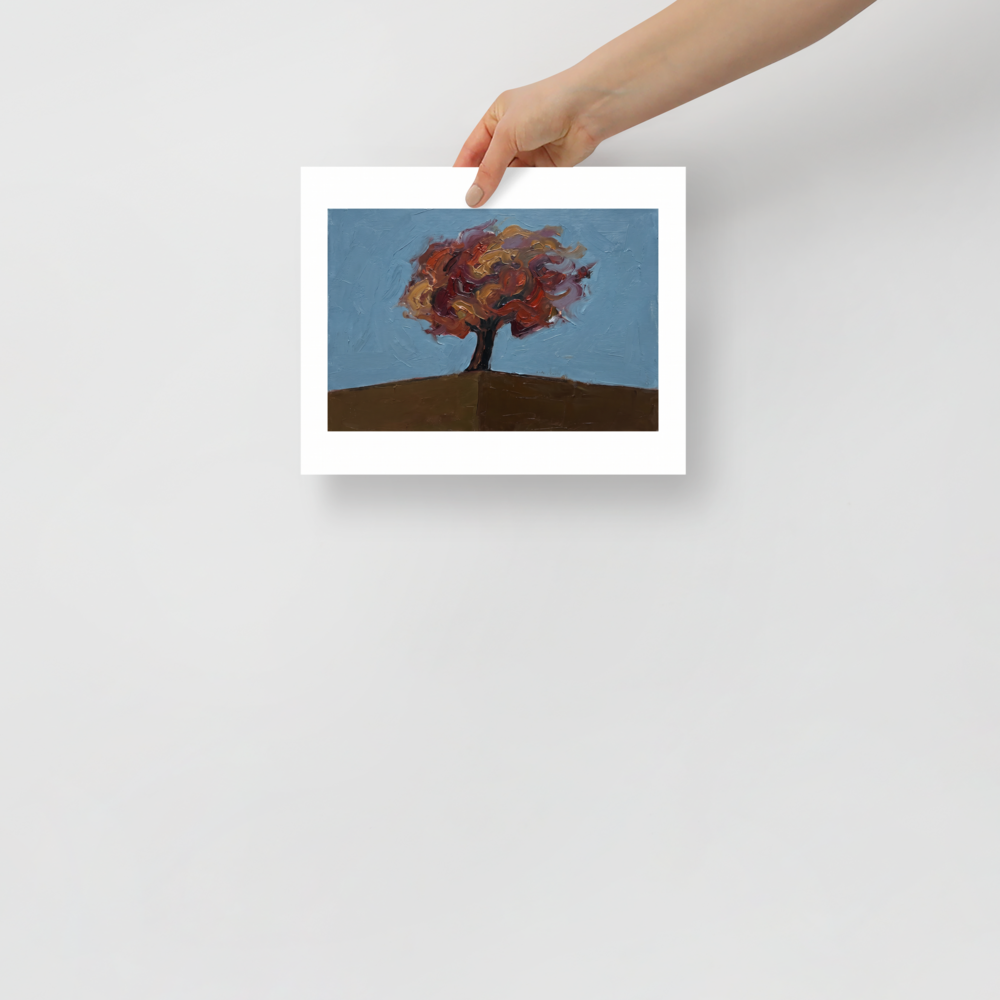 A thick impasto oil painting of a solitary tree with red and gold autumn leaves on a brown hill against a pale blue sky, perfect for a cozy Living Room or Bedroom. Available as the Expressionism art print 'The Lone Autumn'.