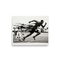 A monochrome black and white artwork of a sprinter exploding off starting blocks, perfect as gym wall art. Available as the Realism art print 'Explosion off the Blocks'.