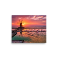 'Flamingos at Dusk' by Meron. A breathtaking photograph of pink flamingos flying across tranquil salt pans at sunset near a traditional windmill, perfect for a peaceful bedroom or living room. A Art photography wall art print.