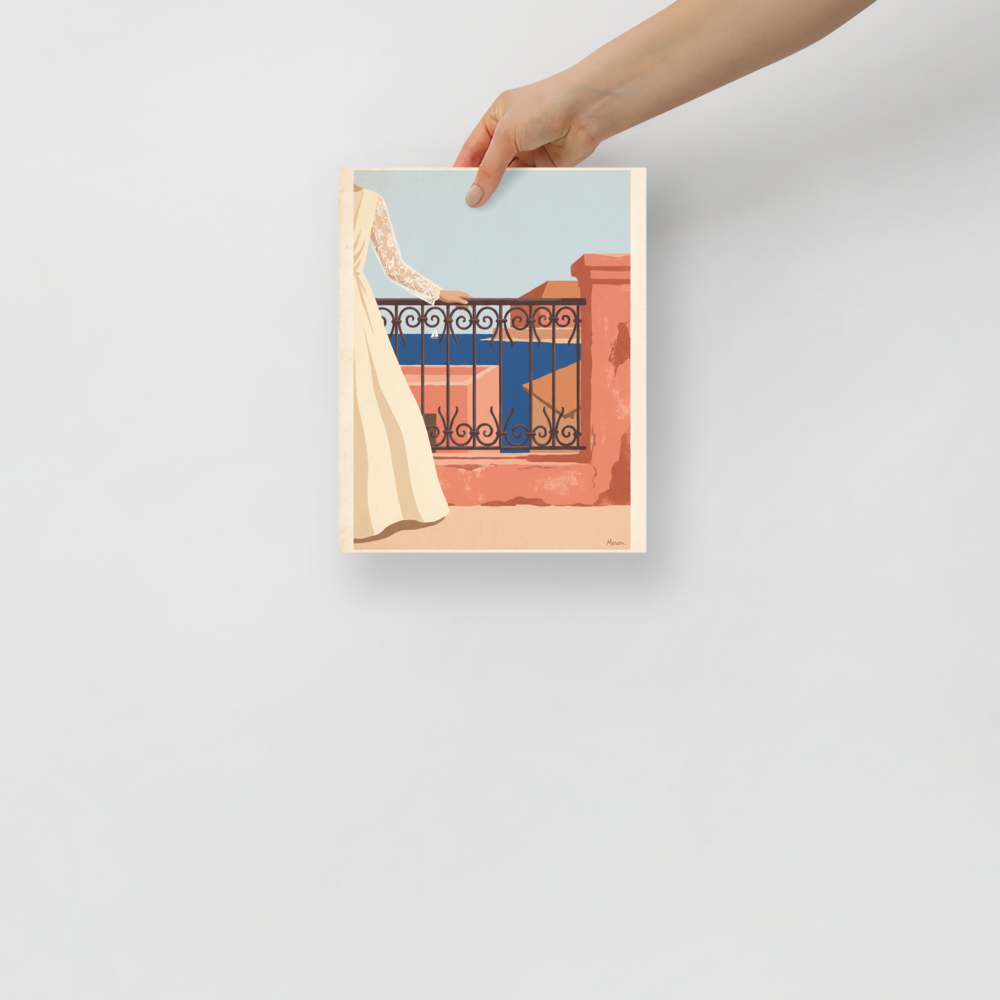 'Coastal Balcony Breeze'. Woman in an ivory lace dress leaning on a wrought iron balcony overlooking a blue sea with a sailboat, ideal for a bedroom. Offered as a Modernism print.