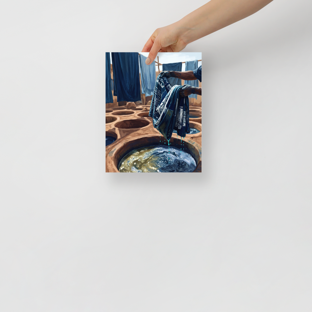 Artisan hands lifting patterned blue cloth from a sunlit clay indigo dye pit, suitable for an artist studio. A Realism art print titled 'The Indigo Dyer'.
