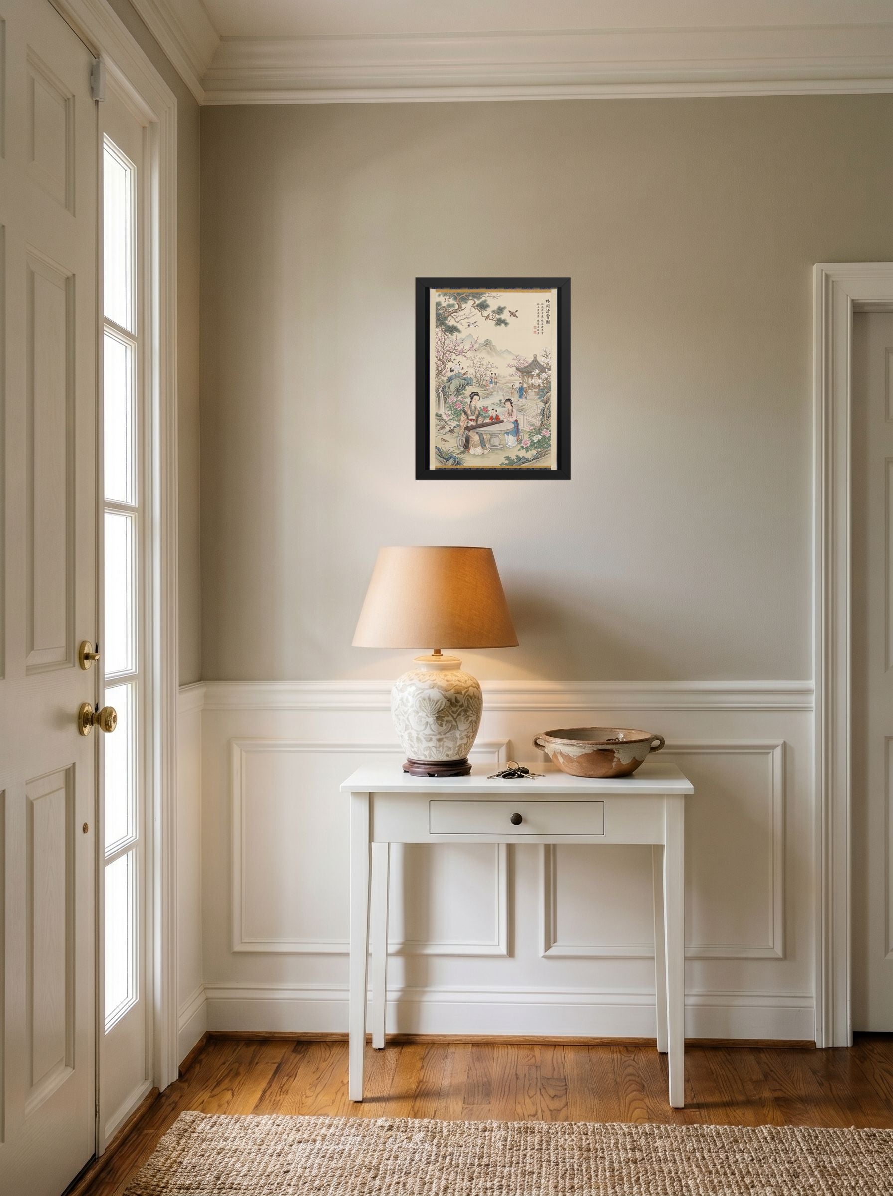 A 12x16 inch black framed Fine Art print of 'Melody in the Spring Garden' hanging in an entryway near a console.