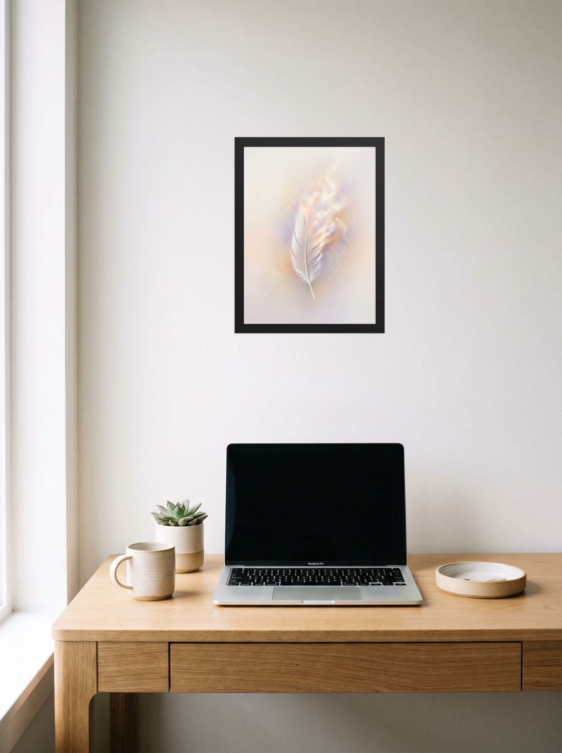 A 12x16 inch black framed Abstract art print of 'Ethereal Plume' hanging above a worktable with a laptop.
