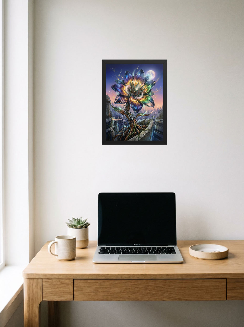 A 12x16 inch black framed Digital art print of 'Cybernetic Bloom' hanging above a worktable with a laptop.