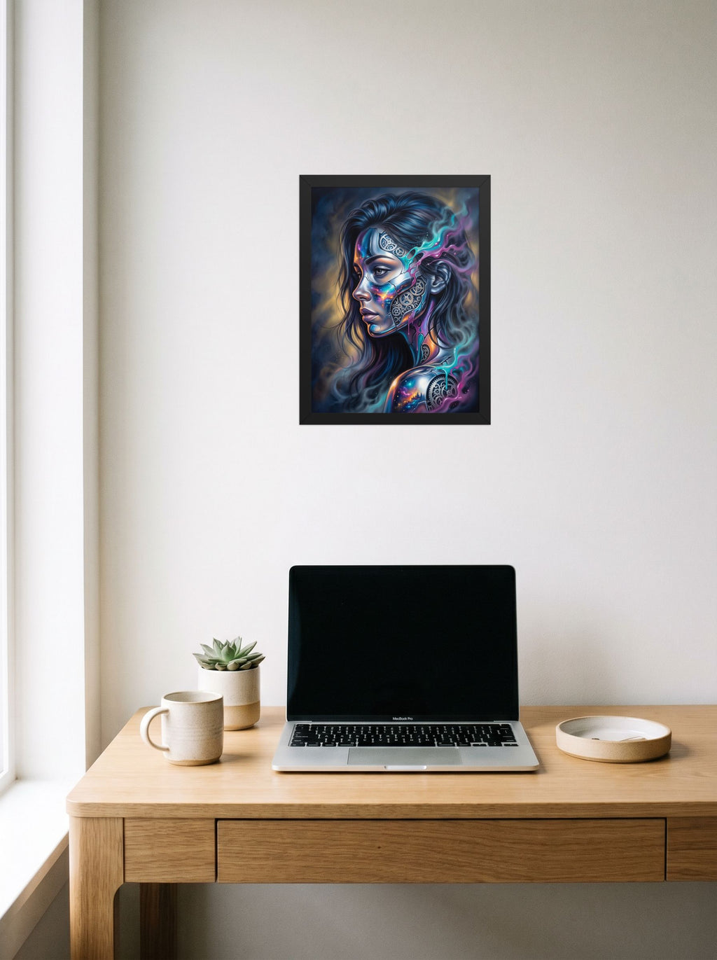 A 12x16 inch black framed Surrealism print of 'Cosmic Clockwork' hanging above a worktable with a laptop.