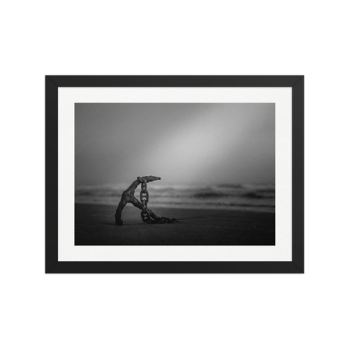 'The Old Anchor' — a Art photography print. A moody black and white photograph of an old rusted anchor and chain resting on a misty beach, a striking nautical piece for a Bathroom.