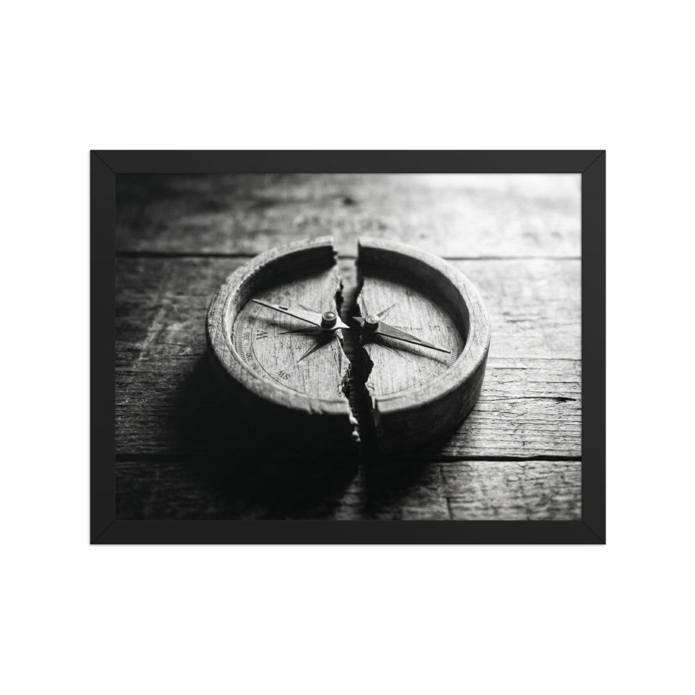 'Lost Direction' — a Art photography print. Dramatic black and white photograph of an antique wooden compass cracked entirely in half on a textured table, ideal for an office or library.