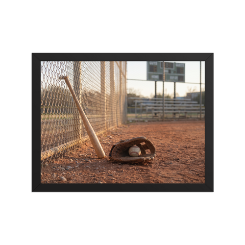 'Field of Memories' — a Art photography print. A photograph of a baseball bat leaning against a fence next to a glove and ball on a dirt field at sunset, a nostalgic piece for a Game Room.