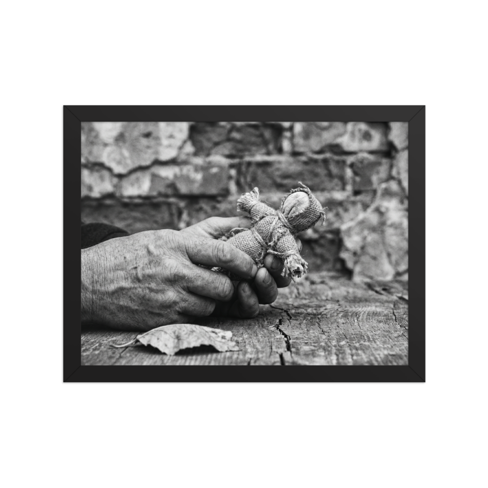 'The Keeper of Memories' — a Art photography print. A black and white photograph of an older person's hands holding a small burlap doll over a cracked wooden table, an atmospheric piece for a Library.
