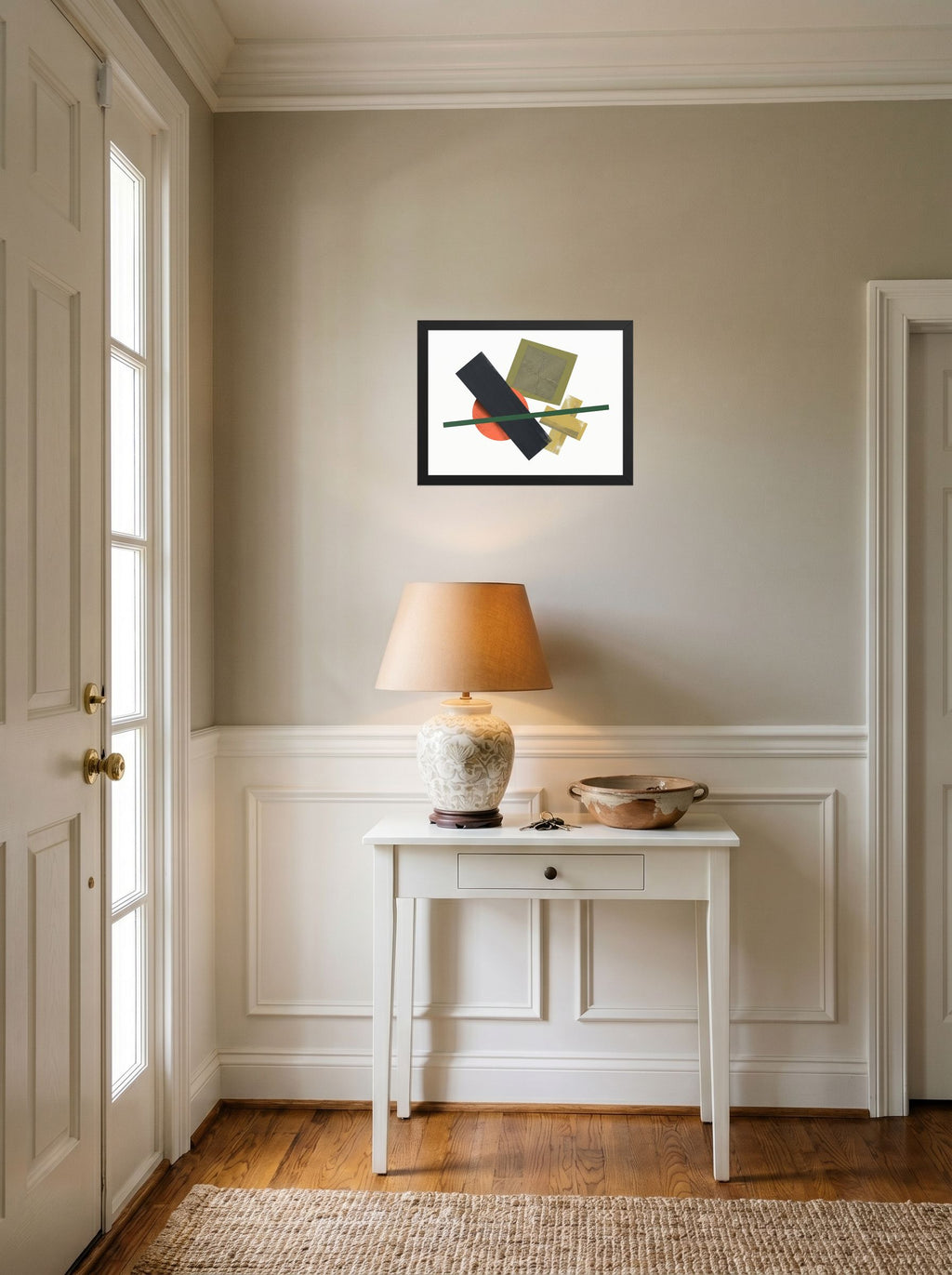A 16x12 inch black framed Suprematism print of 'The Geometry of Sound' hanging in an entryway near a console.