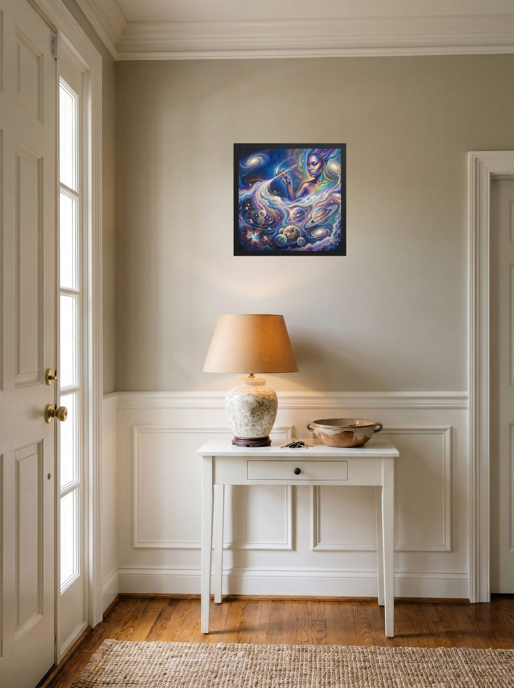 A 16x16 inch black framed Space art print of 'The Cosmic Painter' hanging in an entryway near a console.