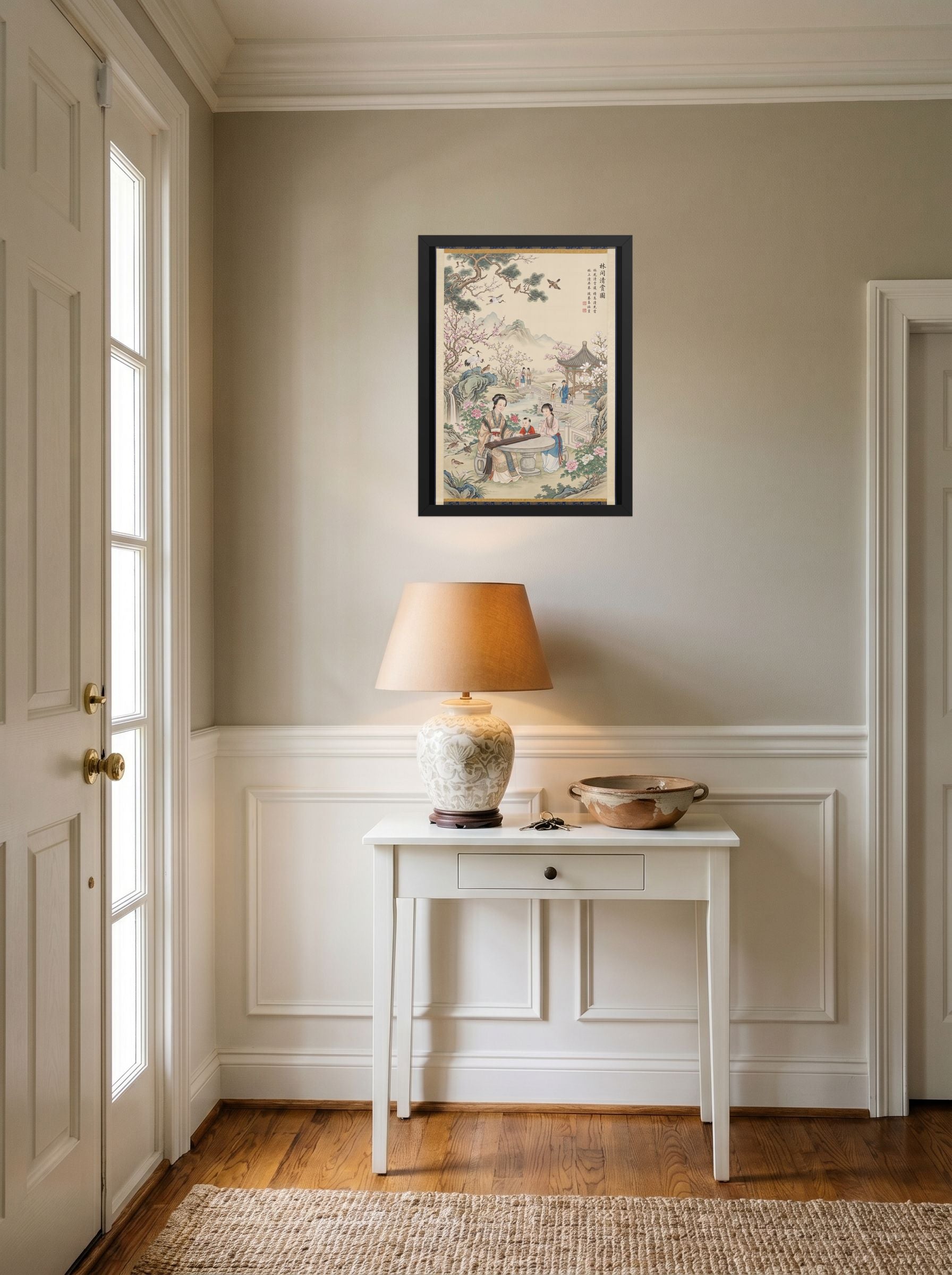 A 18x24 inch black framed Fine Art print of 'Melody in the Spring Garden' hanging in an entryway near a console.