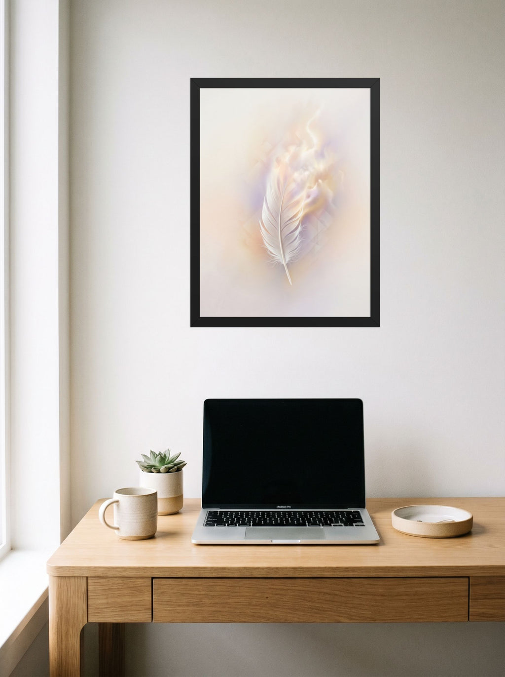 A 18x24 inch black framed Abstract art print of 'Ethereal Plume' hanging above a worktable with a laptop.
