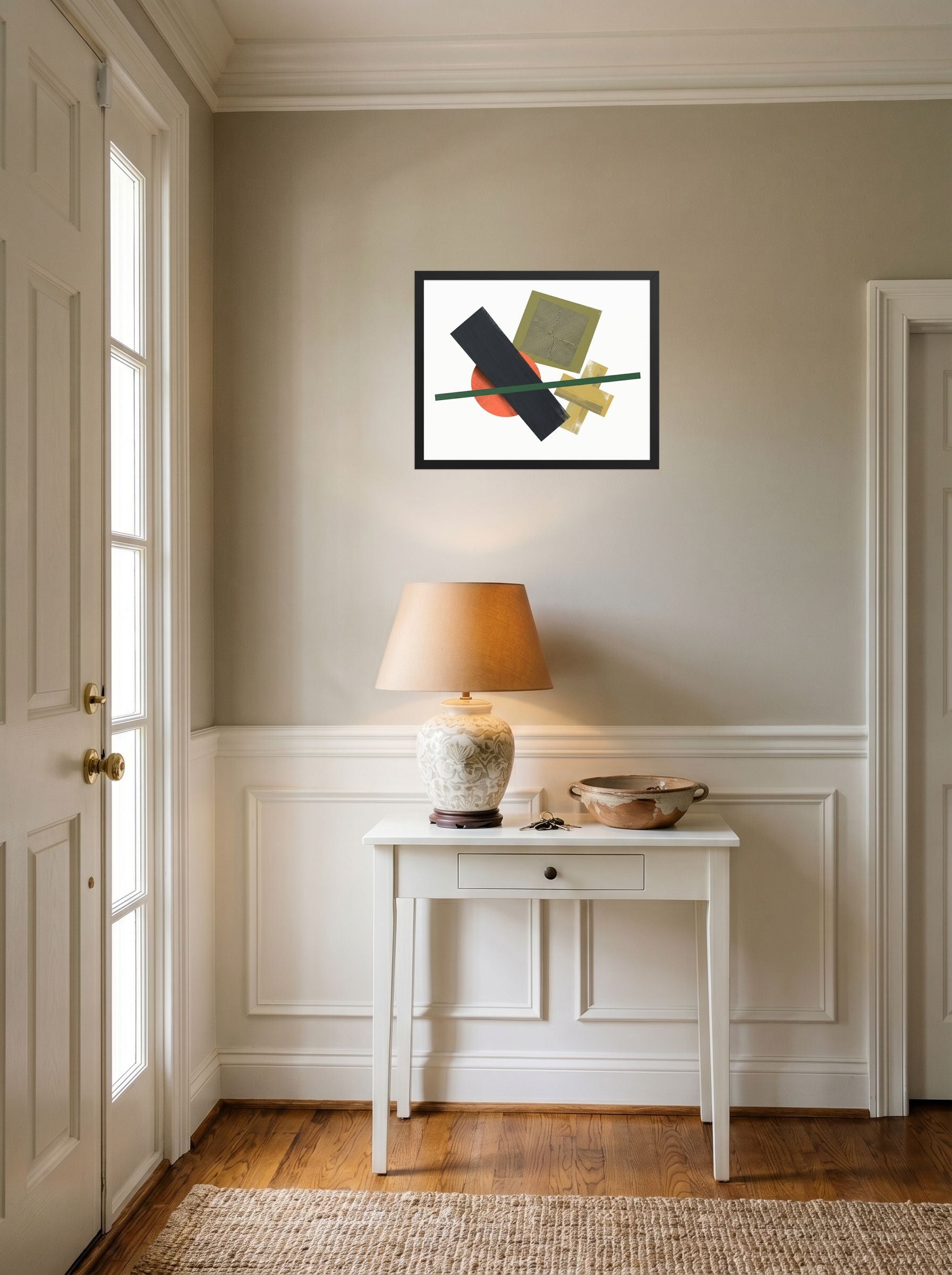 A 20x16 inch black framed Suprematism print of 'The Geometry of Sound' hanging in an entryway near a console.
