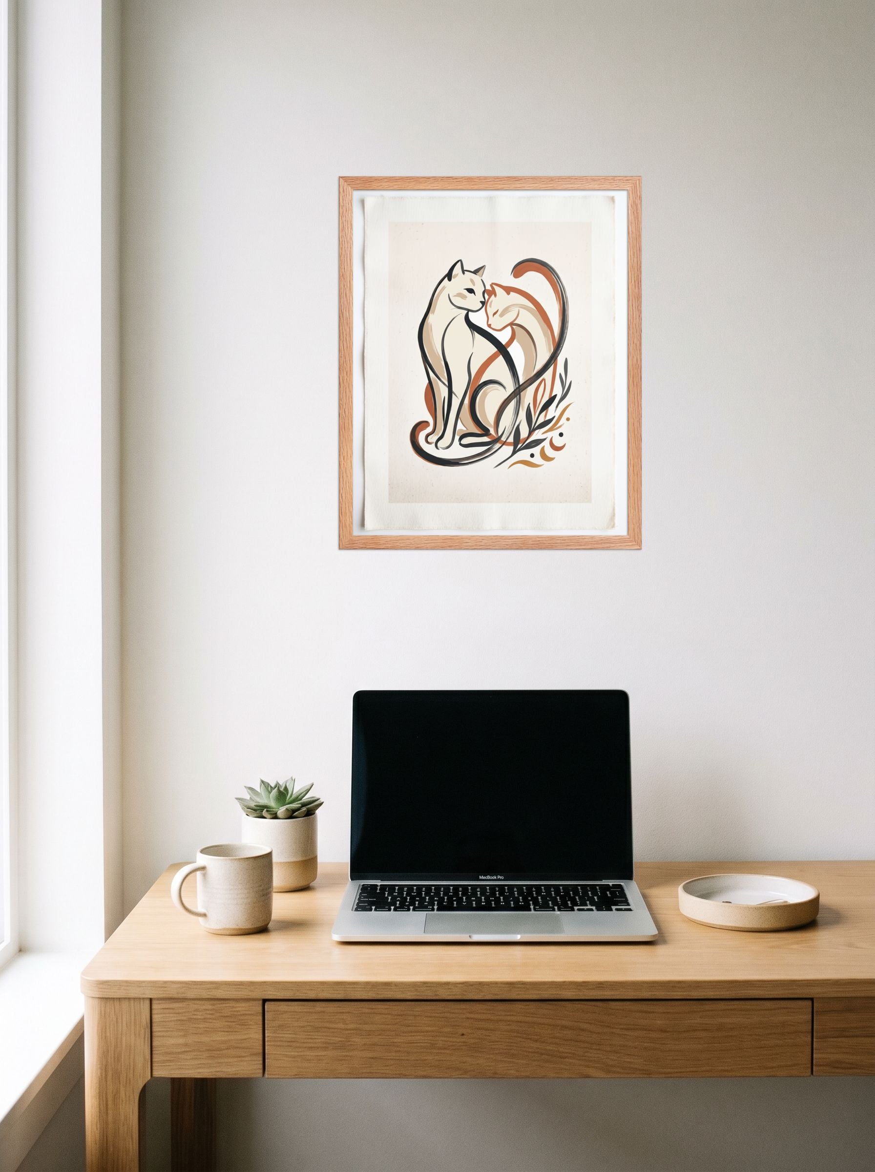 A 16x20 inch redoak framed Minimalism,Abstract art print of 'Feline Affection' hanging above a worktable with a laptop.