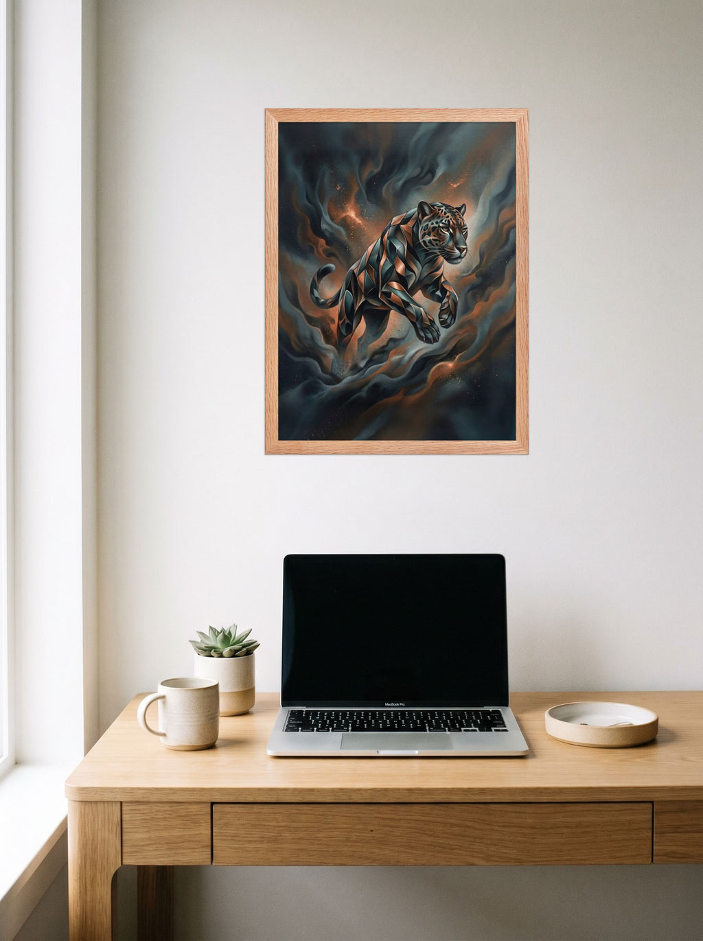 A 18x24 inch redoak framed Digital art print of 'Phantom Leap' hanging above a worktable with a laptop.