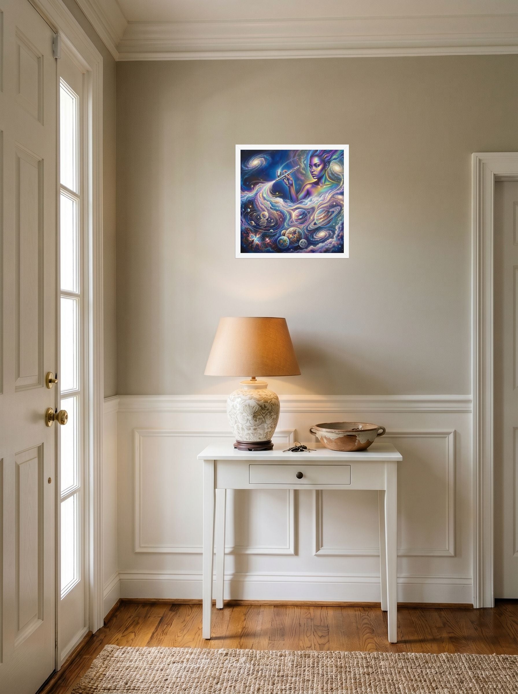 A 16x16 inch white framed Space art print of 'The Cosmic Painter' hanging in an entryway near a console.