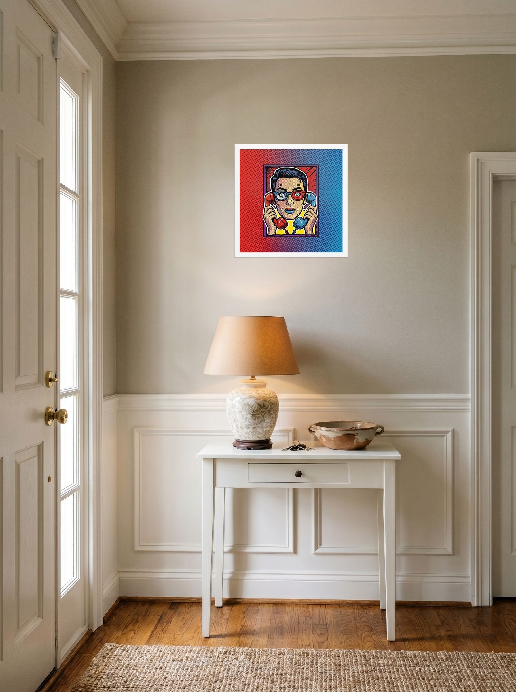 A 16x16 inch white framed Pop art print of 'Bipartisan Static' hanging in an entryway near a console.