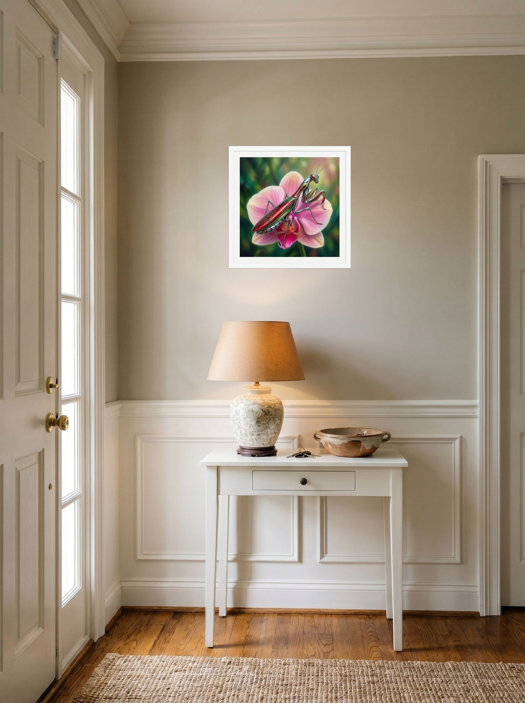A 18x18 inch white framed Surrealism print of 'Chrome Mantis' hanging in an entryway near a console.