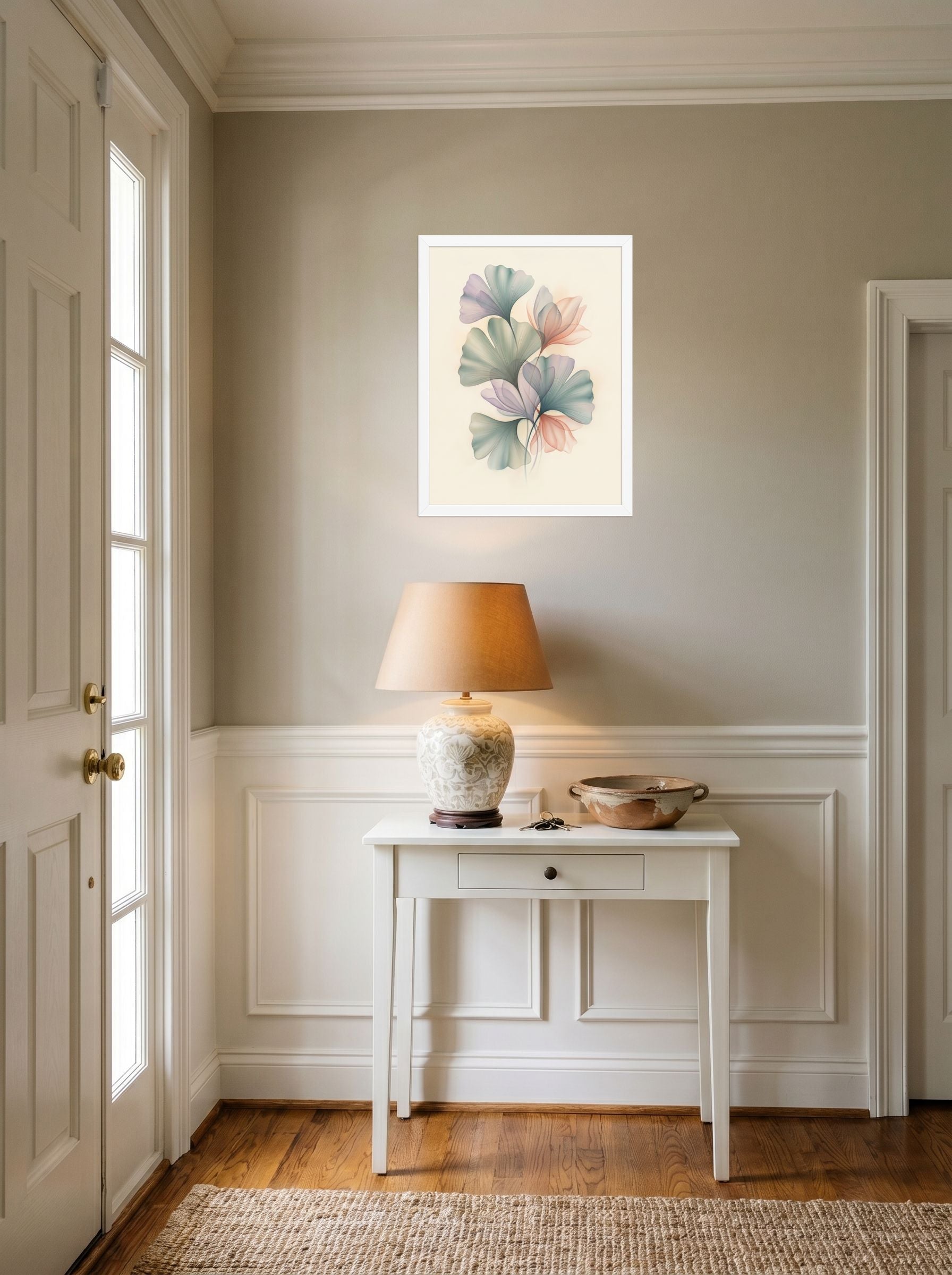 A 18x24 inch white framed Abstract art print of 'Ethereal Ginkgo Whispers' hanging in an entryway near a console.