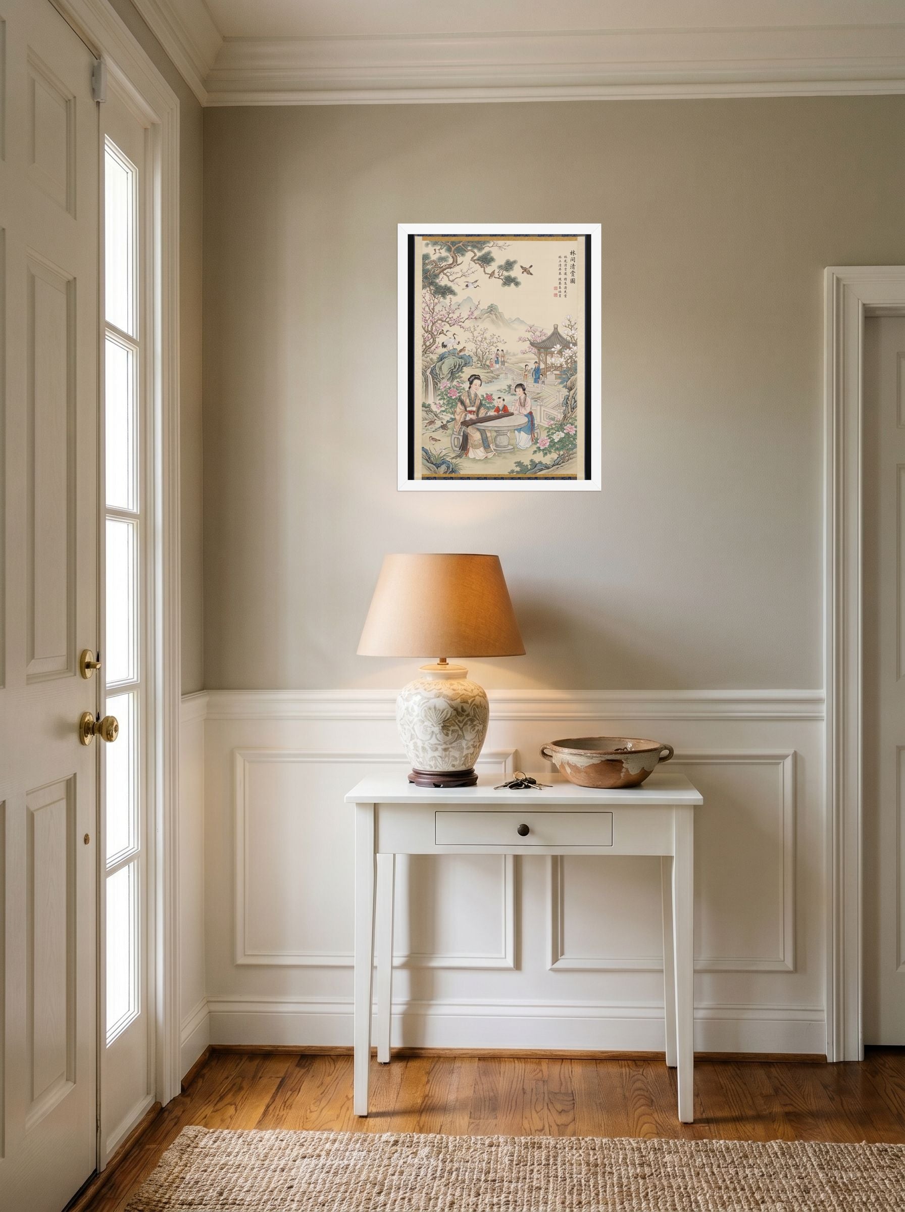 A 18x24 inch white framed Fine Art print of 'Melody in the Spring Garden' hanging in an entryway near a console.