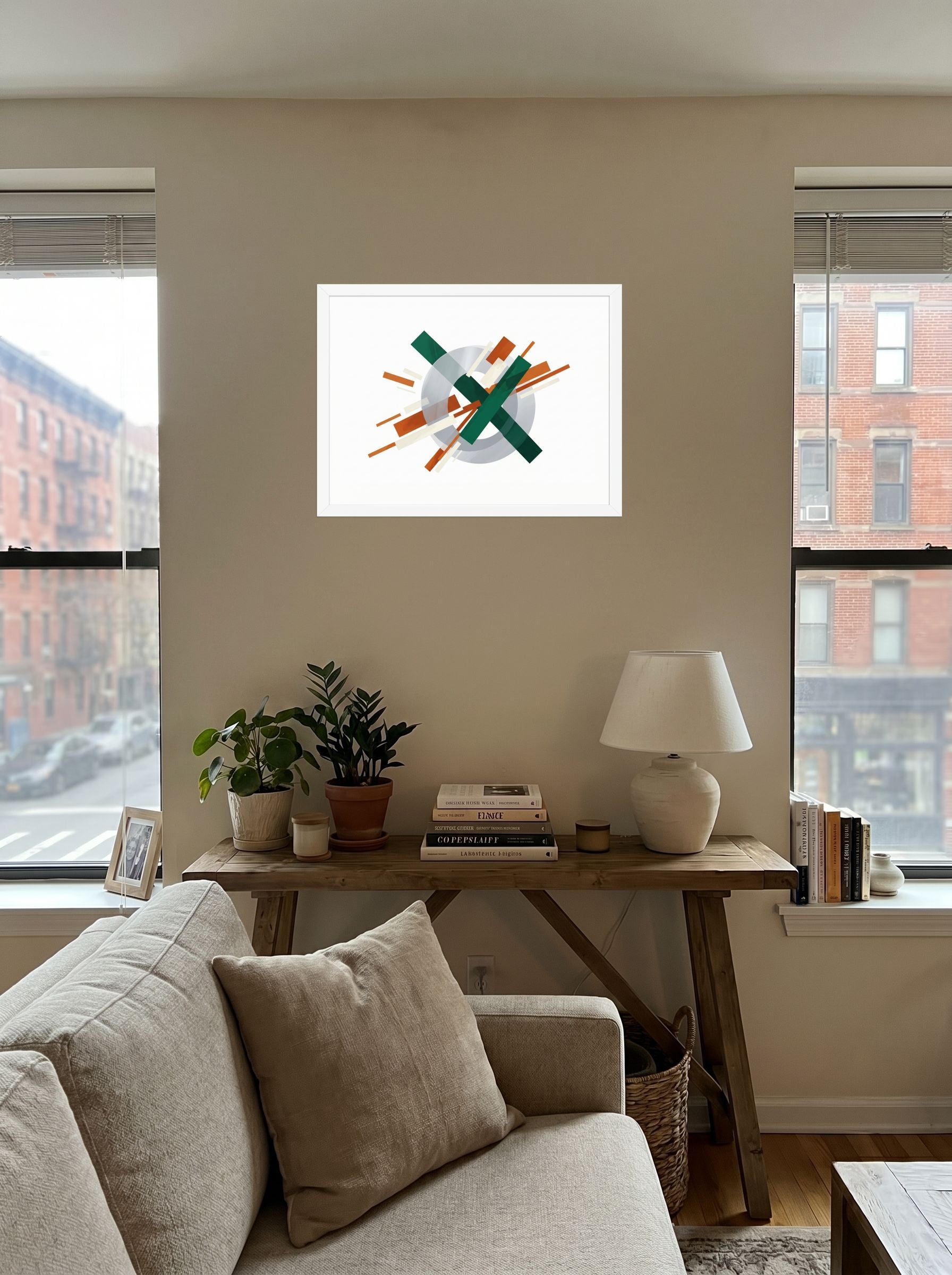 A 24x18 inch white framed Suprematism print of 'Intersecting Perspectives' displayed in the center of a living room.