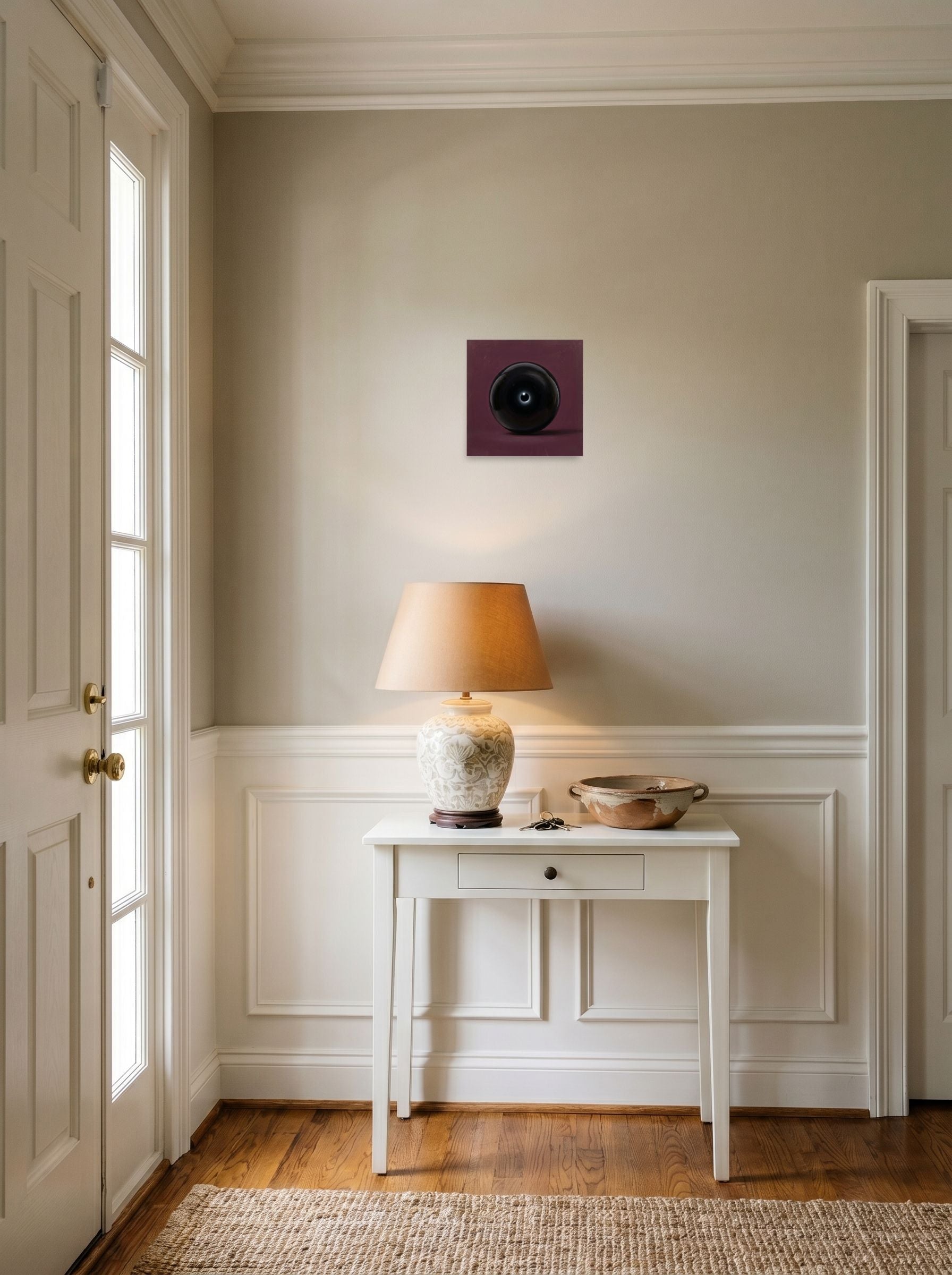 A 10x10 inch unframed paper Surrealism print of 'Obsidian Eye' hanging in an entryway near a console.