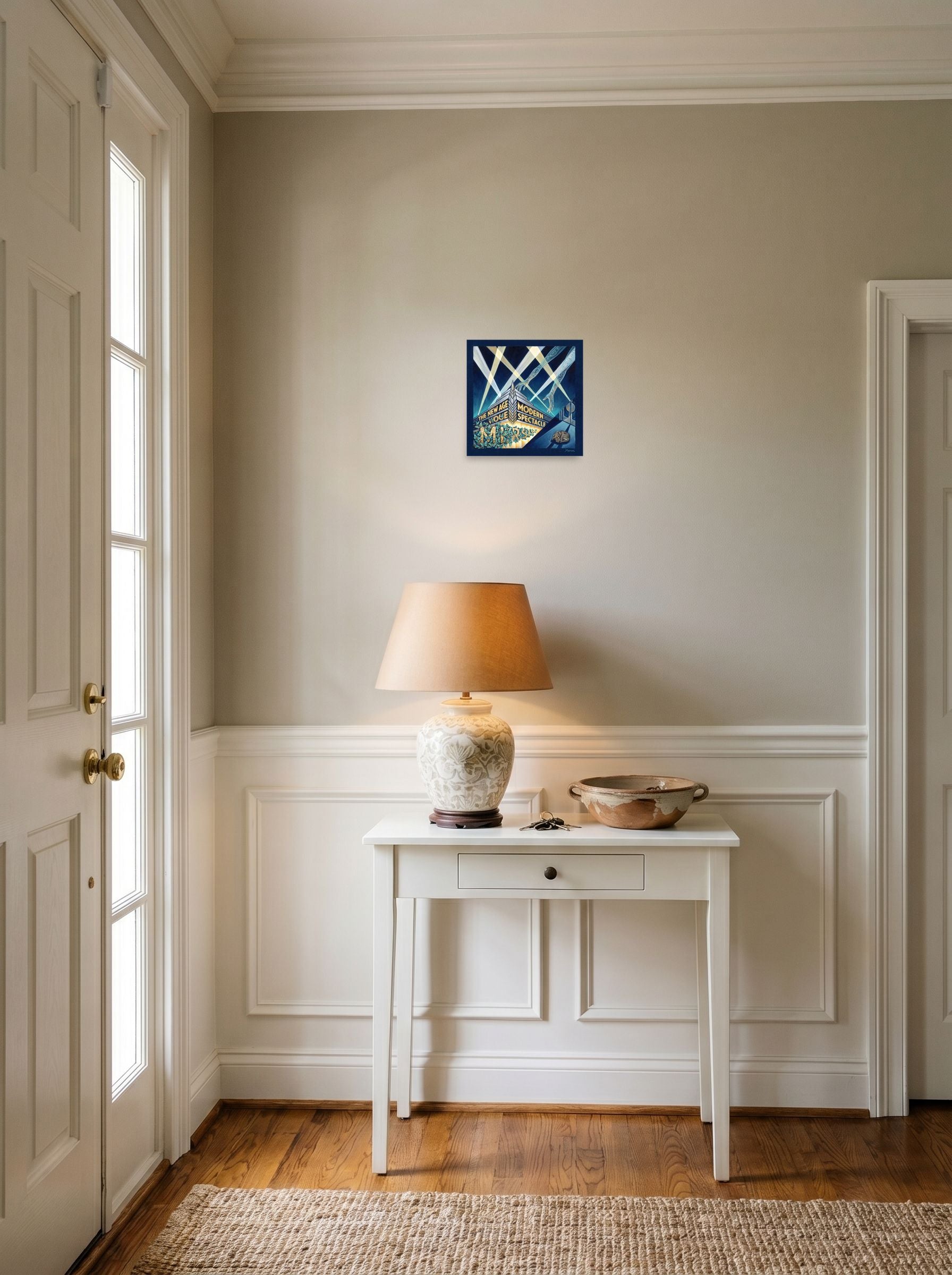 A 10x10 inch unframed paper Art Deco print of 'The New Age Spectacle' hanging in an entryway near a console.