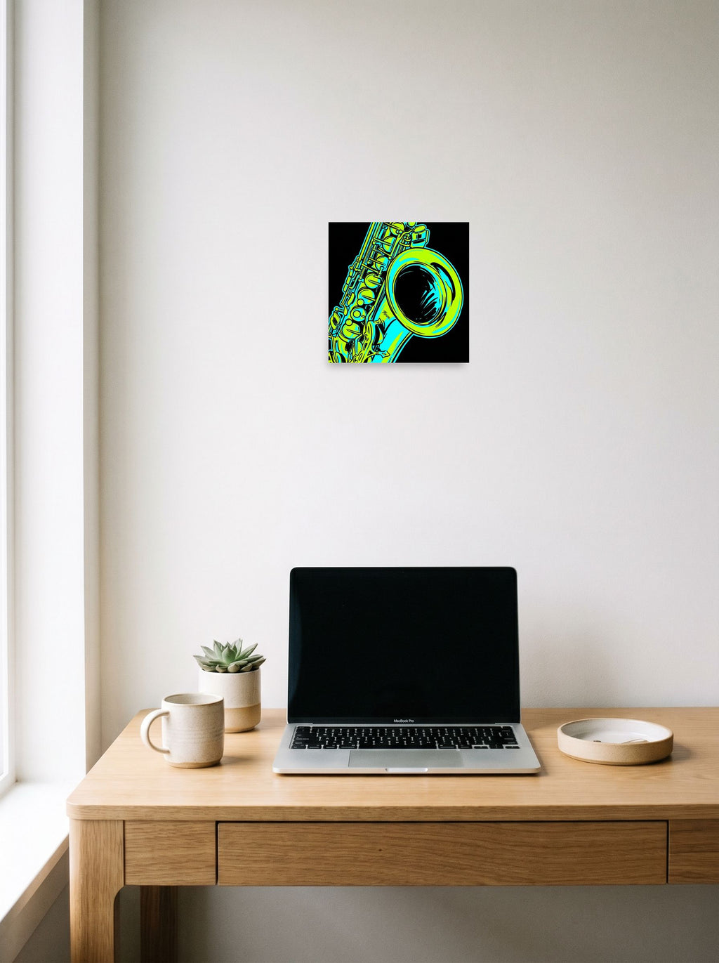 A 10x10 inch unframed paper Pop art print of 'Neon Rhythms' hanging above a worktable with a laptop.