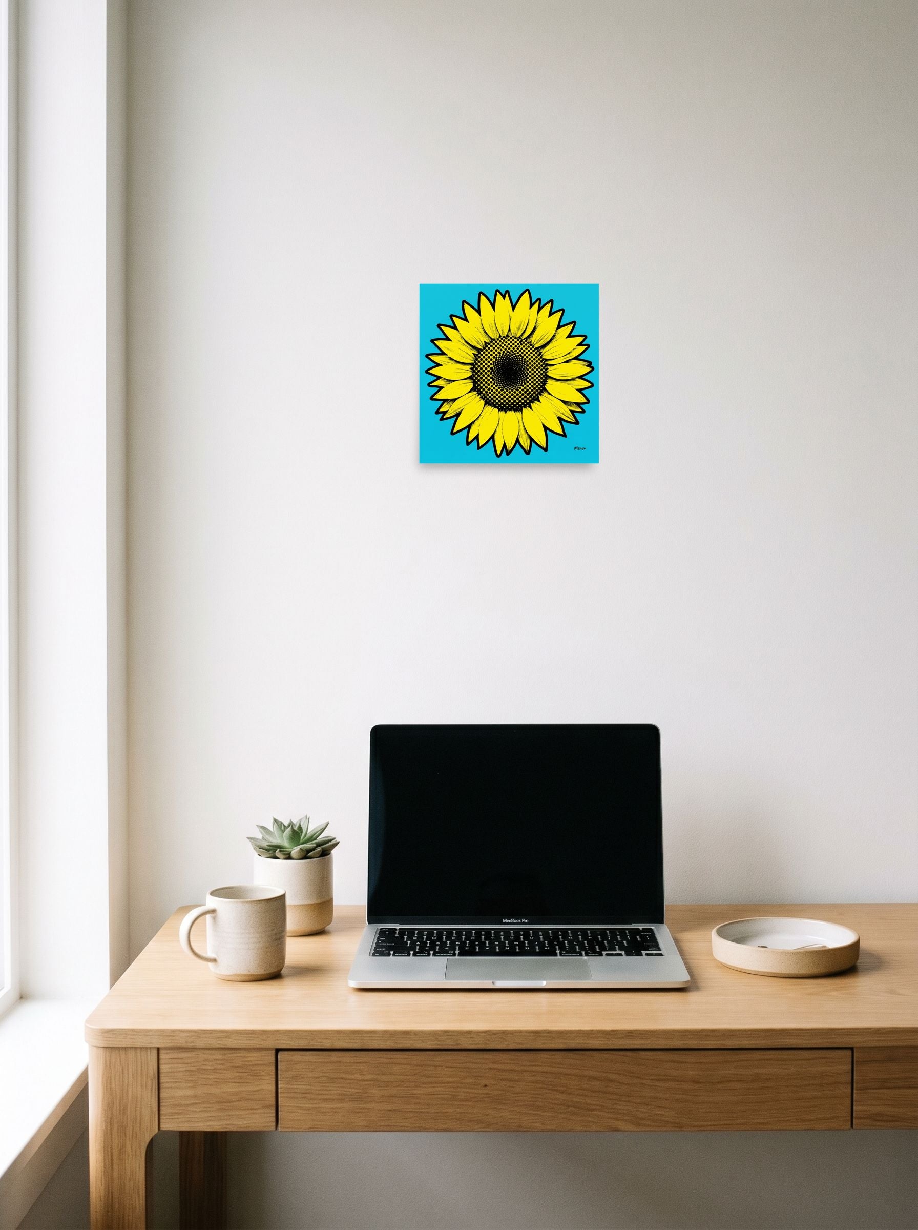 A 10x10 inch unframed paper Pop art print of 'Cyan Sunflower' hanging above a worktable with a laptop.