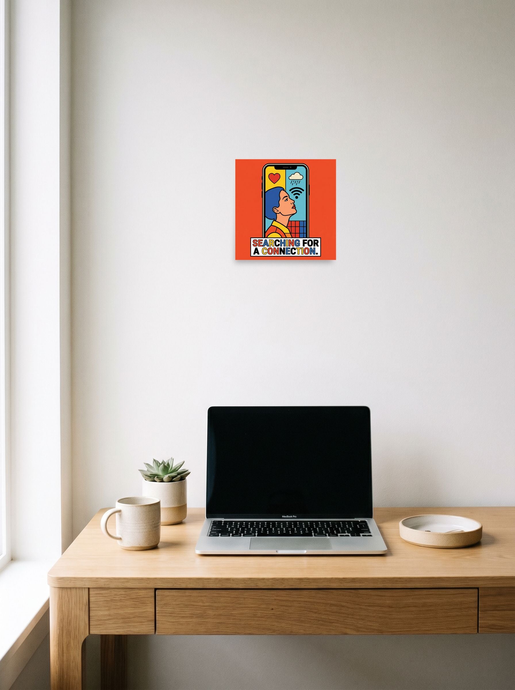 A 10x10 inch unframed paper Pop art print of 'Signal Lost' hanging above a worktable with a laptop.