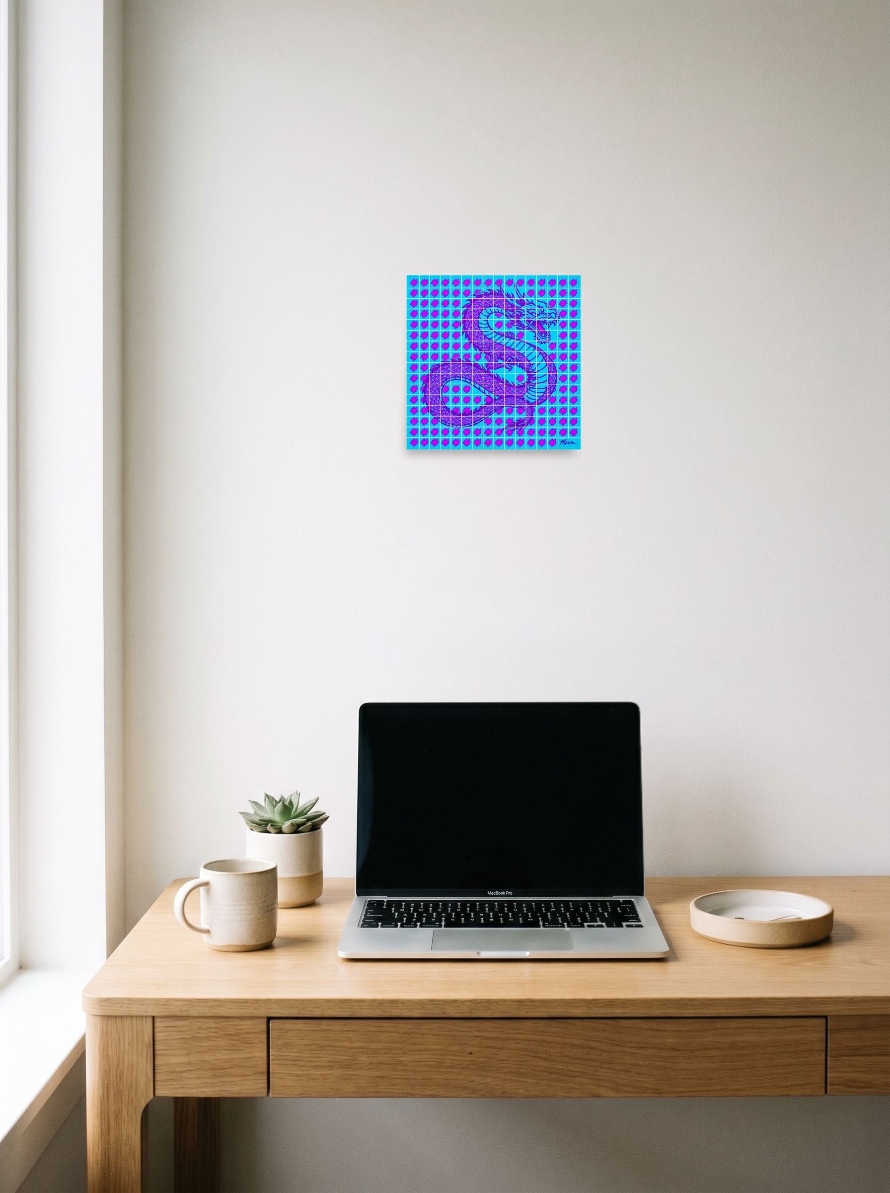 A 10x10 inch unframed paper Pop art print of 'Neon Dragon Grid' hanging above a worktable with a laptop.