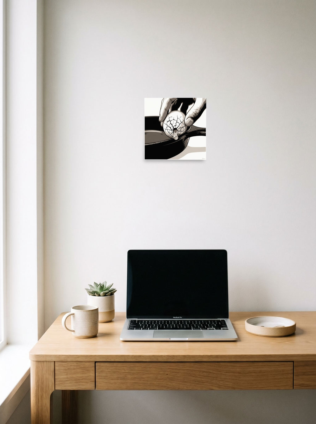 See 'Cracking the Shell' as a unframed paper print (10x10 inch), hanging above a worktable with a laptop.