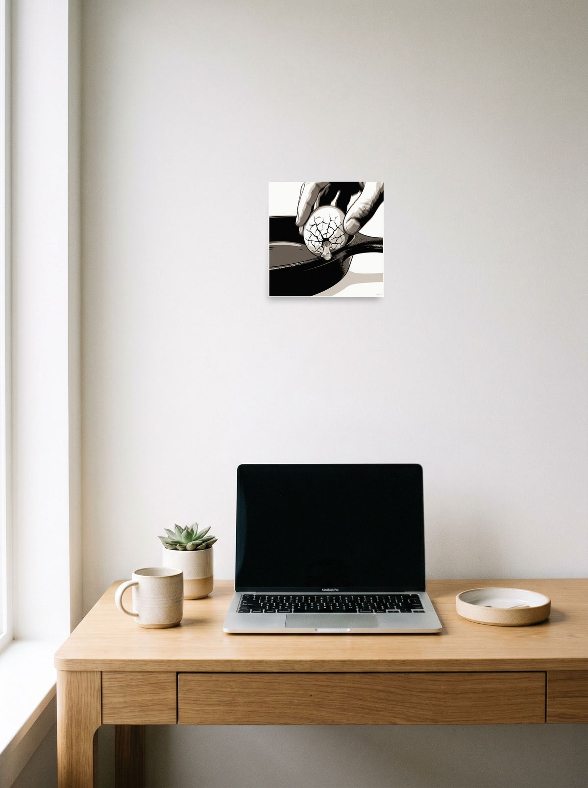 See 'Cracking the Shell' as a unframed paper print (10x10 inch), hanging above a worktable with a laptop.