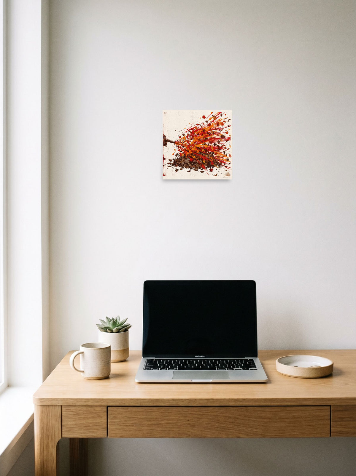 A unframed paper print of the Pop art artwork 'Autumn Blast', displayed over a compact desk setup.