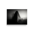 'Echoes in the Mist' — a Art photography print. A moody black and white photograph of a lone figure walking into dense fog next to an old stone wall, ideal for a modern Office or Den.