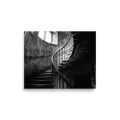 'Ascending Shadows' — a Art photography print. A black and white photograph of a winding stone staircase bathed in dramatic natural light, an elegant focal point for a Hallway.