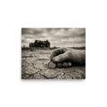 'The Last Coin' — a American realism print. A sepia-toned photograph of a worn, gloved hand holding a coin on cracked earth, with an abandoned house in the background, suitable for a rustic Office or Living Room.