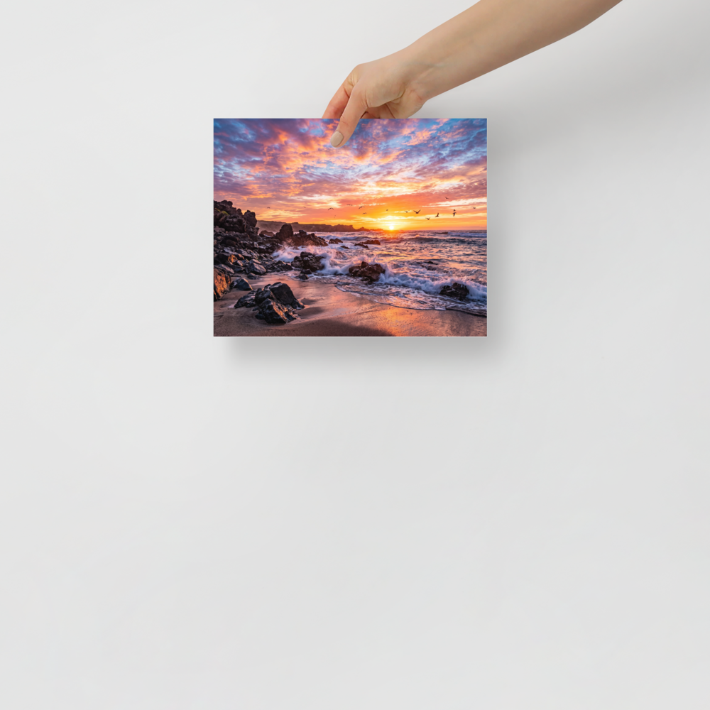 'Coastal Fire' — a Art photography print. A vibrant photograph of a sunset over a rocky beach with crashing waves and birds flying in the distance, a beautiful piece for a Living Room.
