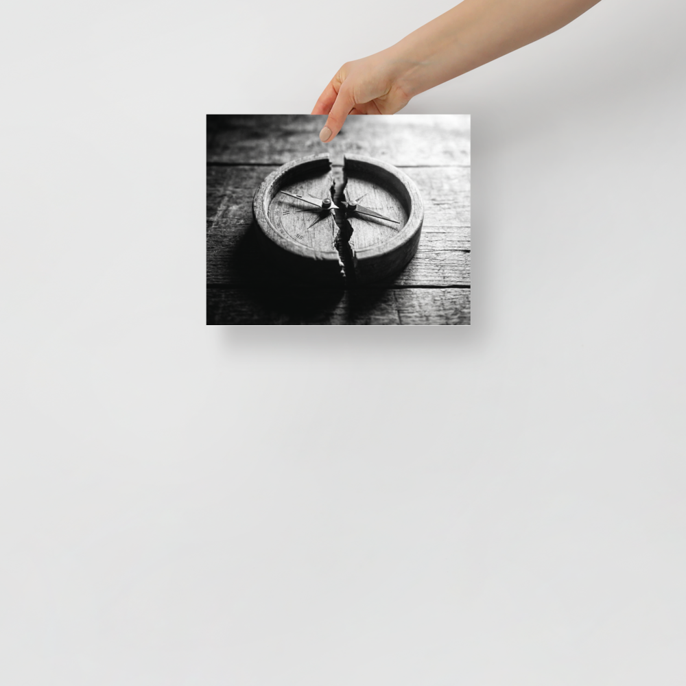 'Lost Direction' — a Art photography print. Dramatic black and white photograph of an antique wooden compass cracked entirely in half on a textured table, ideal for an office or library.