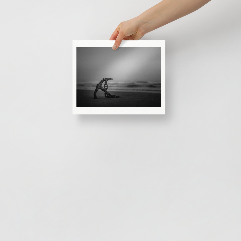 'The Old Anchor' — a Art photography print. A moody black and white photograph of an old rusted anchor and chain resting on a misty beach, a striking nautical piece for a Bathroom.