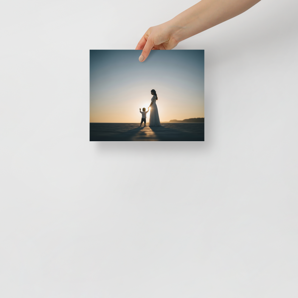 'Sunset Bond' — a Art photography print. A warm sunset silhouette of a mother in a long dress holding her child's hand on a wide beach, a beautiful and emotional piece for a cozy Bedroom.