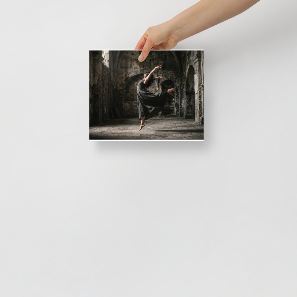 'Grace in the Ruins' — a Art photography print. A photograph of a dancer leaping gracefully in a dark flowing dress inside a ruined stone building, bringing a sense of movement to a Living Room or Studio.