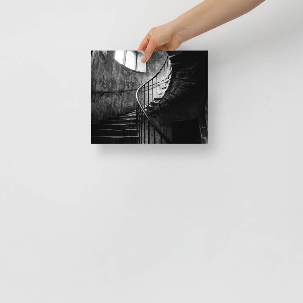 'Ascending Shadows' — a Art photography print. A black and white photograph of a winding stone staircase bathed in dramatic natural light, an elegant focal point for a Hallway.