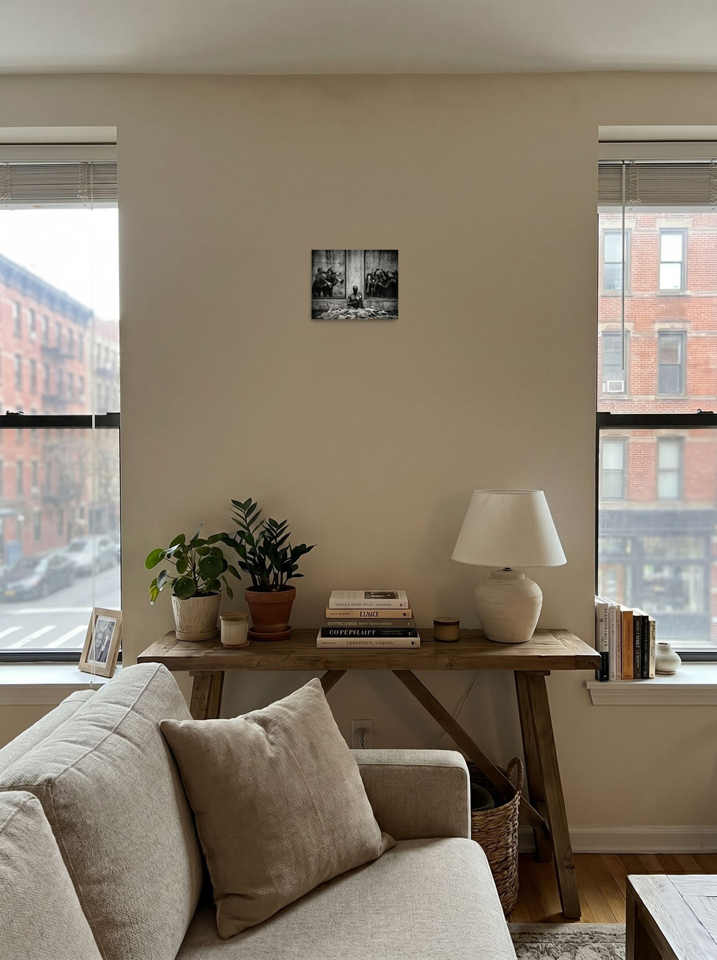 A 10x8 inch unframed paper Surrealism print of 'The Spectacle' displayed in the center of a living room.