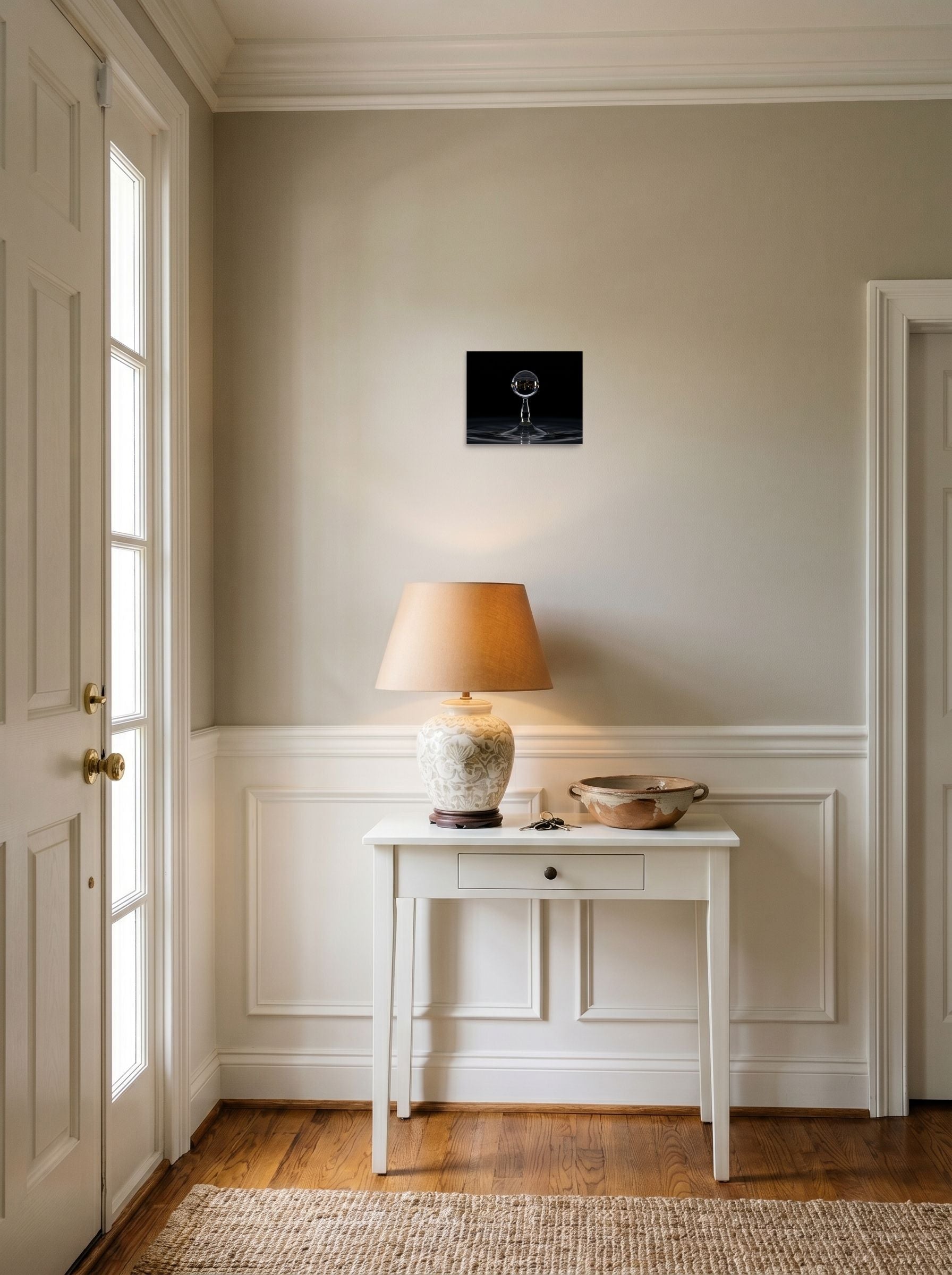 A 10x8 inch unframed paper Surrealism print of 'City in a Drop' hanging in an entryway near a console.